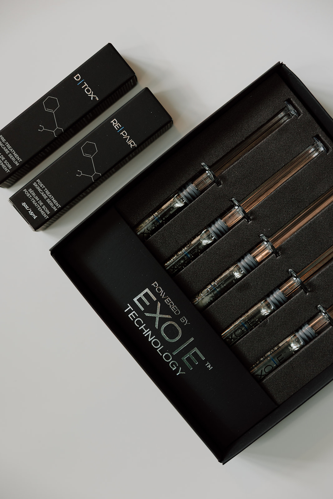 Exosome serums are displayed in syringes in the original packaging, ready to be used for treatment.