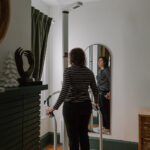 A woman stands on EA's SECA mBCA Body Composition Scan