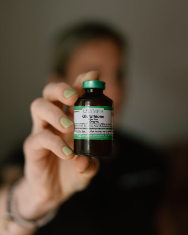 Kasia holds a vial of Glutathione