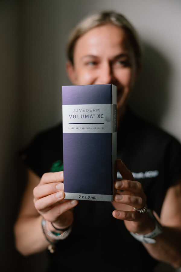 Kasia holds Juvederm product box.